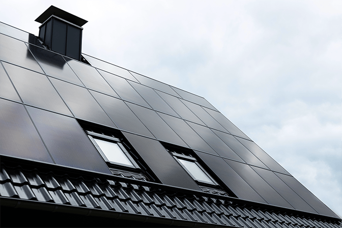 Eine von enivon gebaute Photovoltaikanlage auf einem Bestandsgebäude mit dunklen Panels